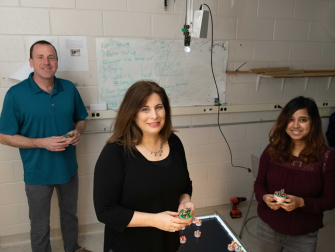 Dana Randall, Daniel Goldman, and Bahnisikha Dutta work together on creating magnetic robots. This photo was taken in 2019 at Georgia Tech as part of a previous research study (Credit: Allison Carter, Georgia Tech)