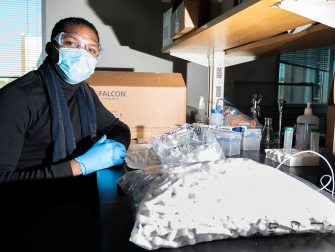 A staff member assembles kits for campus Covid-19 surveillance testing