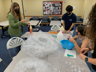 From L to R: Little Einstein Organization volunteers Madison Cochran, Eduardo Ramirez Velez, Sydney Bules, and Anna Cobb put together homemade Silly Putty kits. (Photo: Olivia Gravina)